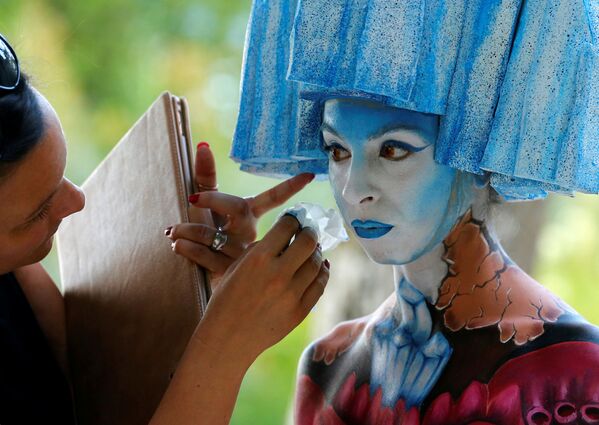 Uma artista retoca a pintura na modelo durante o Festival Mundial de Bodypainting em Portschach, no dia 1 de julho de 2016 - Sputnik Brasil