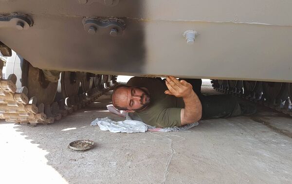 Um militar iraniano examina um tanque antes dos Jogos do Exército na Rússia - Sputnik Brasil