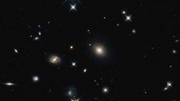 The image shows the foreground lensing galaxy (observed with Hubble), and the gravitationally lensed galaxy SDP.81, which forms an almost perfect Einstein Ring, is hardly visible. - Sputnik Brasil