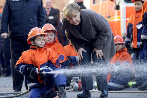 A chanceler alemã Angela Merkel, em 14 de novembro, durante um encontro em Berlim com jovens bombeiros - Sputnik Brasil