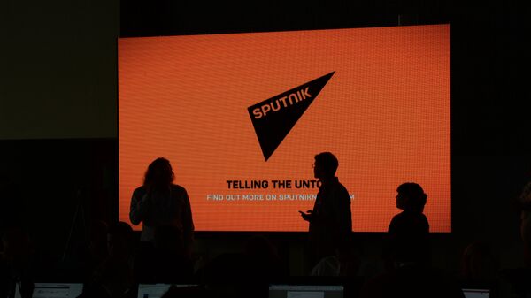 A screen with the logo of the Sputnik international news agency and radio - Sputnik Brasil