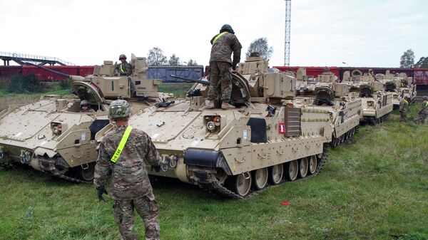 Members of the US Army 1st Brigade, 1st Cavalry Division, unload Bradley Fighting Vehicles at the railway station near the Rukla military base in Lithuania, on October 4, 2014 - Sputnik Brasil