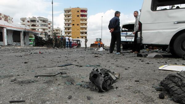 Syrians gather at the scene of multiple bombings in the the city of Tartus northwest of Damascus. File photo - Sputnik Brasil