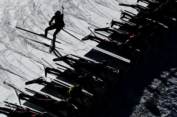 Atletas na linha de fogo durante a competição feminina da Copa de Biatlo, na Itália. - Sputnik Brasil