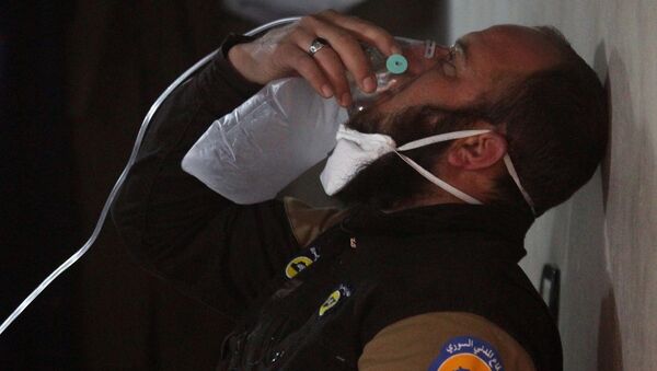 Membro da defesa civil respira via máscara de oxigênio depois do ataque na cidade de Khan Sheikhoun, na Síria, com alegado uso de armas químicas, 4 de abril de 2017 - Sputnik Brasil