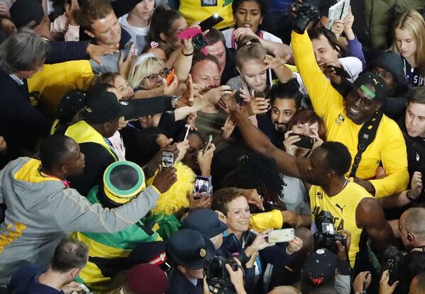 Usain Bolt é abraçado por torcedores após a corrida. - Sputnik Brasil