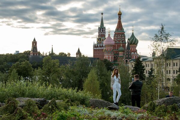 Os visitantes do novo parque de natureza e ambiente Zaryadye em Moscou, tendo como pano de fundo a Torre Spasskaya e a Catedral de São Basílio - Sputnik Brasil
